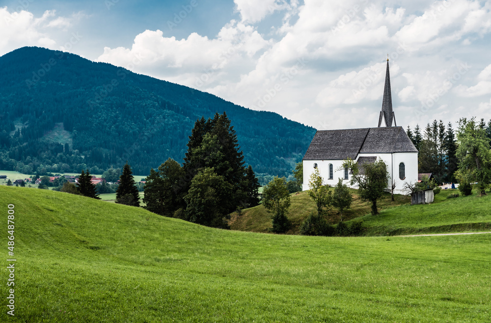 Scenic view of a chapel and green hills over the German countryside in the village Kappel