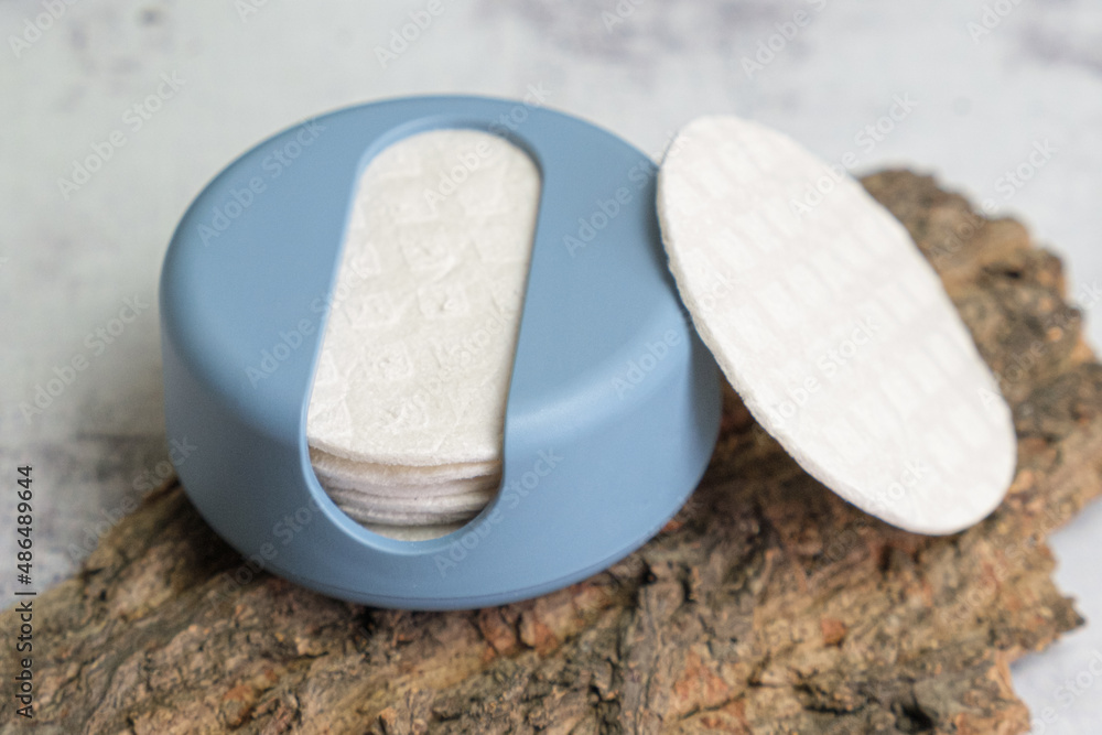 Reusable Cotton Rounds makeup remover in a container made from recycled ocean plastic on tree bark. Zero waste pads for to reduce environmental pollution. Reusable Cotton Rounds makeup remover in a container made from recycled ocean plastic on tree bark. Zero waste pads for to reduce environmental pollution.