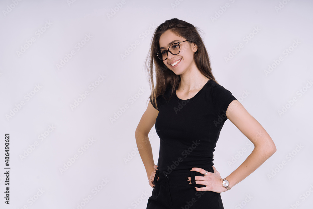 Young Female model in studio. high fashion portrait of young elegant woman. skinny black pants, black heels shoes. Young Female model in studio. high fashion portrait of young elegant woman. skinny black pants, black heels shoes.