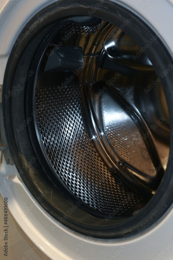 washing machine drum. open washing machine door. washing process. white