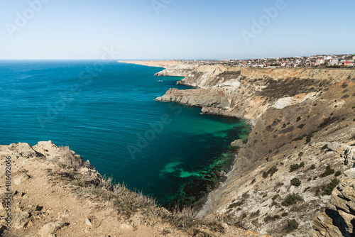View of Crimean rugged rocky with Diana's Grotto and beach from top of the cliff on Fiolent Cape. Sevastopol. Crimea