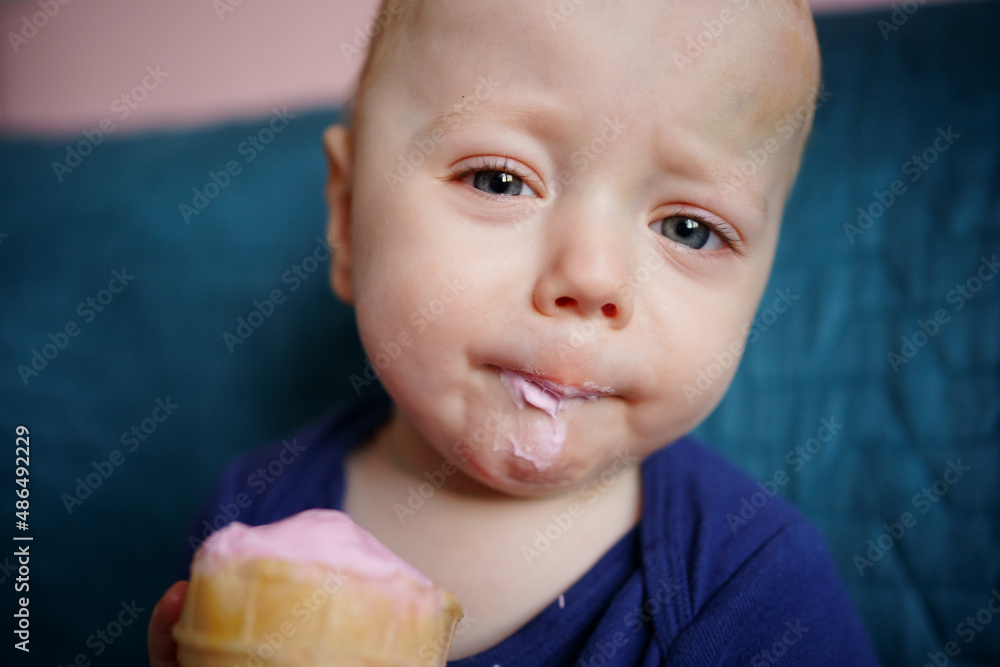 child eats pink ice cream. High quality photo child eats pink ice cream. High quality photo
