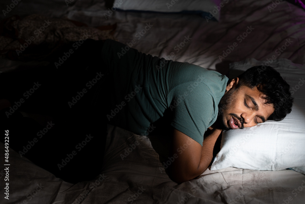 young man having nice comfortable sleep at time - concept of healthy lifestyle, relaxation and taking nap young man having nice comfortable sleep at time - concept of healthy lifestyle, relaxation and taking nap