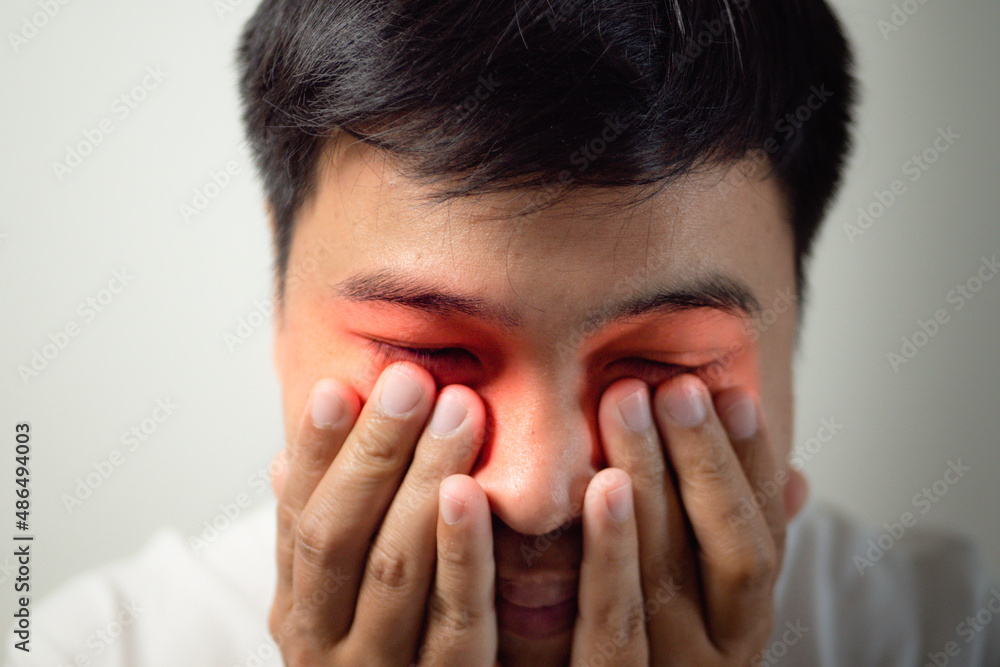 The man pains his eyes. He touches his eye by hands. Ophthalmology concept. This shot is medium close up portrait. The man pains his eyes. He touches his eye by hands. Ophthalmology concept. This shot is medium close up portrait.
