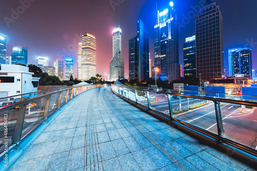 Photography Freeway in night with cars light in modern city.