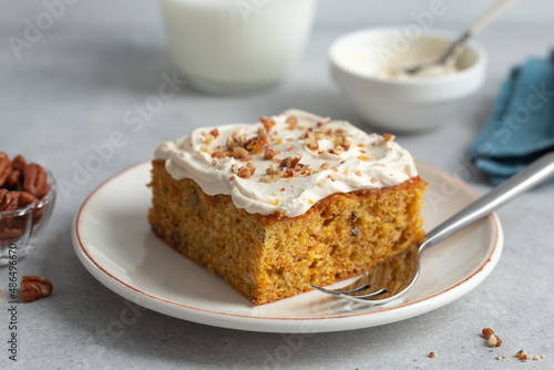 carrot cake with nuts and  cream cheese frosting photo