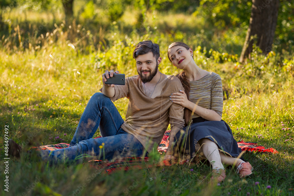 young couple taking a selfie in nature young couple taking a selfie in nature