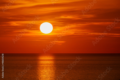 Fototapeta Naklejka Na Ścianę i Meble -   Fantastic sunset over ocean. The sun goes down over the sea. Dramatic Sunset Sky