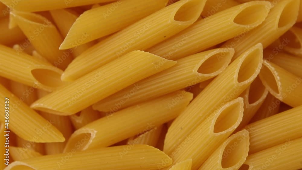 Rotation raw dry pasta penne, Vegetarian Healthy Organic Food Diet, Macro, Italian pasta ready to be cooked Rotation raw dry pasta penne, Vegetarian Healthy Organic Food Diet, Macro, Italian pasta ready to be cooked