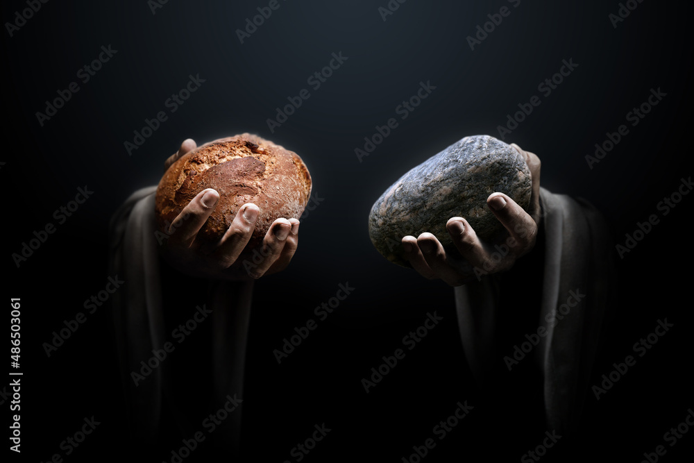 Hands of a man holding a stone and a bread. Religious biblical theme concept. - obrazy, fototapety, plakaty 
