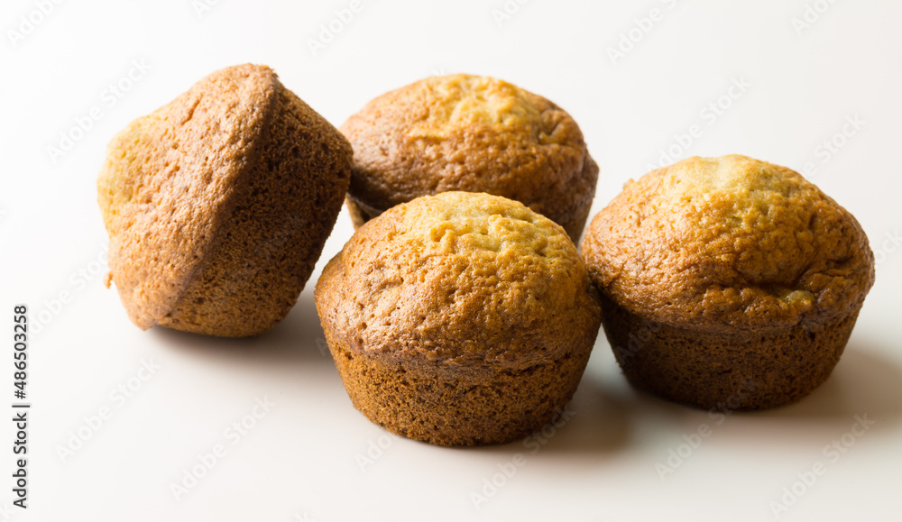 Small muffins isolated on white - little baked sweet cakes Small muffins isolated on white - little baked sweet cakes
