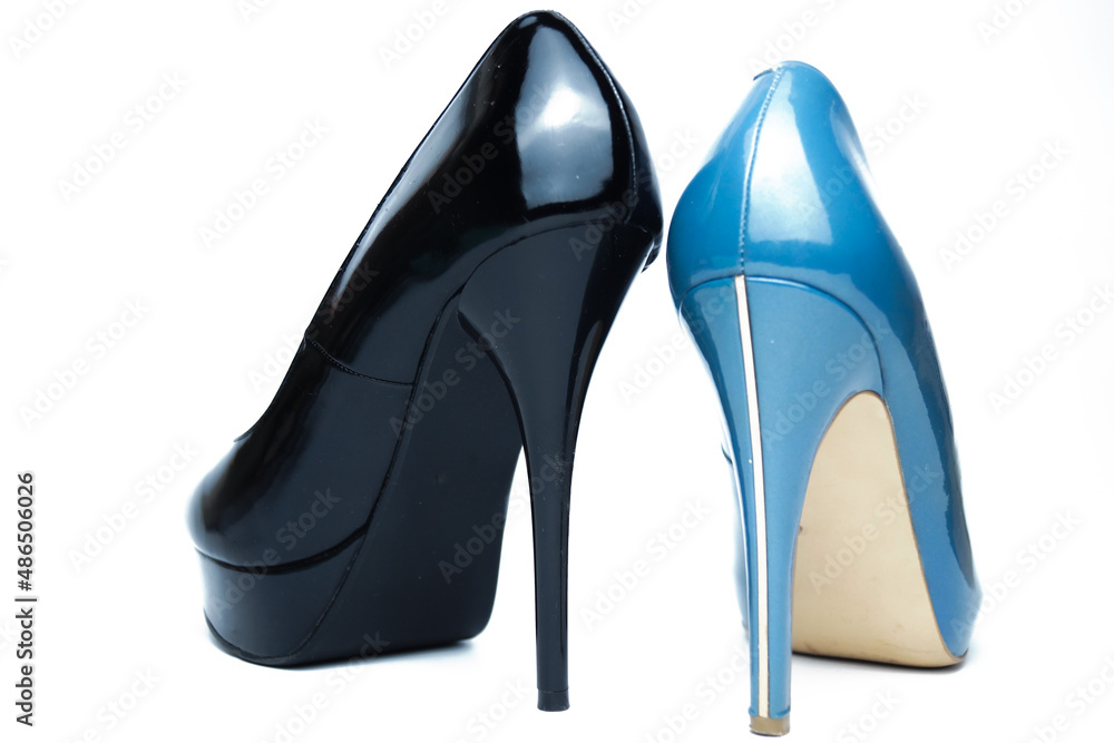 Sexy women's black and blue high-heeled shoes of different models. Isolated on a white background. The concept of choice. Sexy women's black and blue high-heeled shoes of different models. Isolated on a white background. The concept of choice.