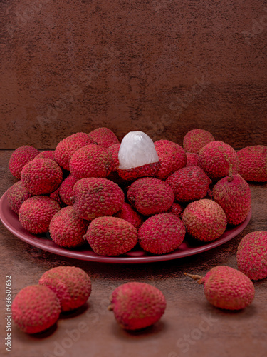Lychee berries on the table, middle plan vertical format