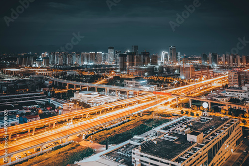 Freeway in night with cars light in modern city. © H stock