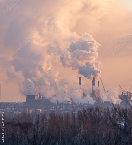 Smoke from the chimneys of a steel plant at sunset © schankz