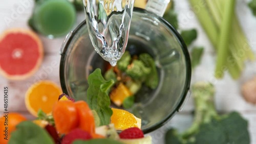 Fresh fruit and vegetables smoothie blended in blender, top view. Healthy eating concept. Super slow motion filmed on high speed cinematic camera. photo