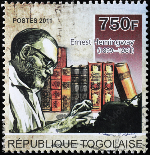 Ernest Hemingway at the typewriter on postage stamp
