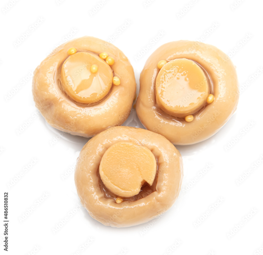 Pickled champignons isolated on a white background. Pickled champignons isolated on a white background.