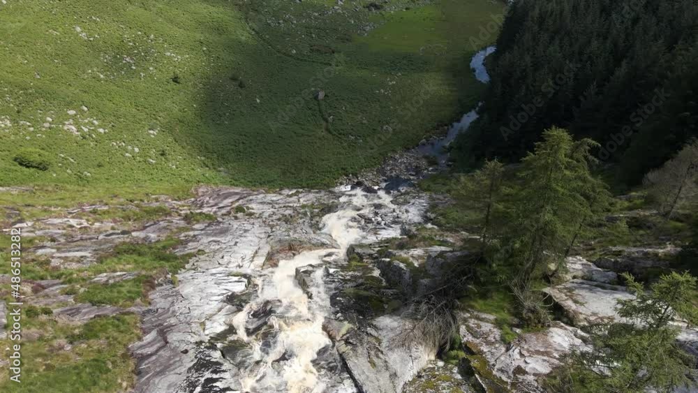Drone shot of a waterfall in Ireland on a summers day. Drone shot of a waterfall in Ireland on a summers day.
