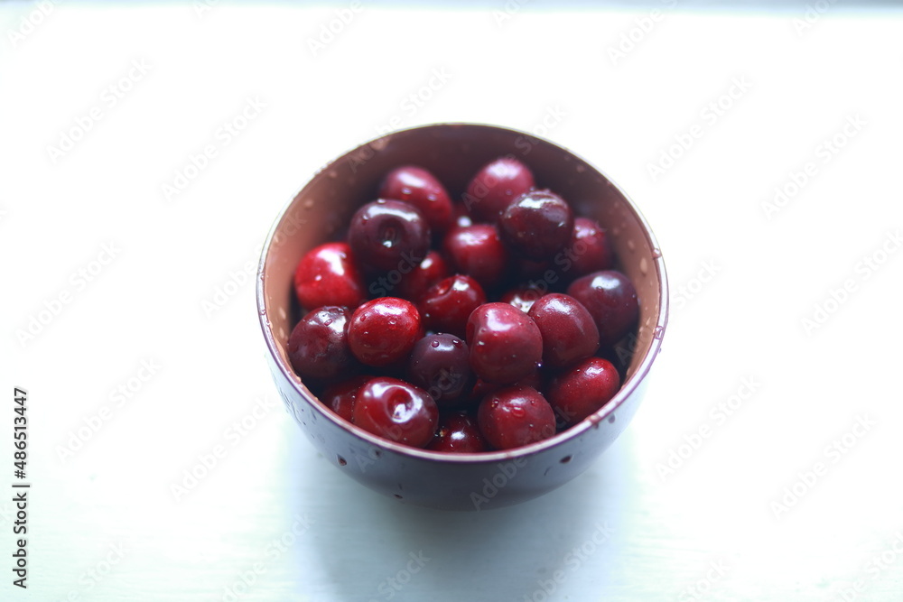 Bowl of ripe sweet cherries on the windowsill. Bowl of ripe sweet cherries on the windowsill.