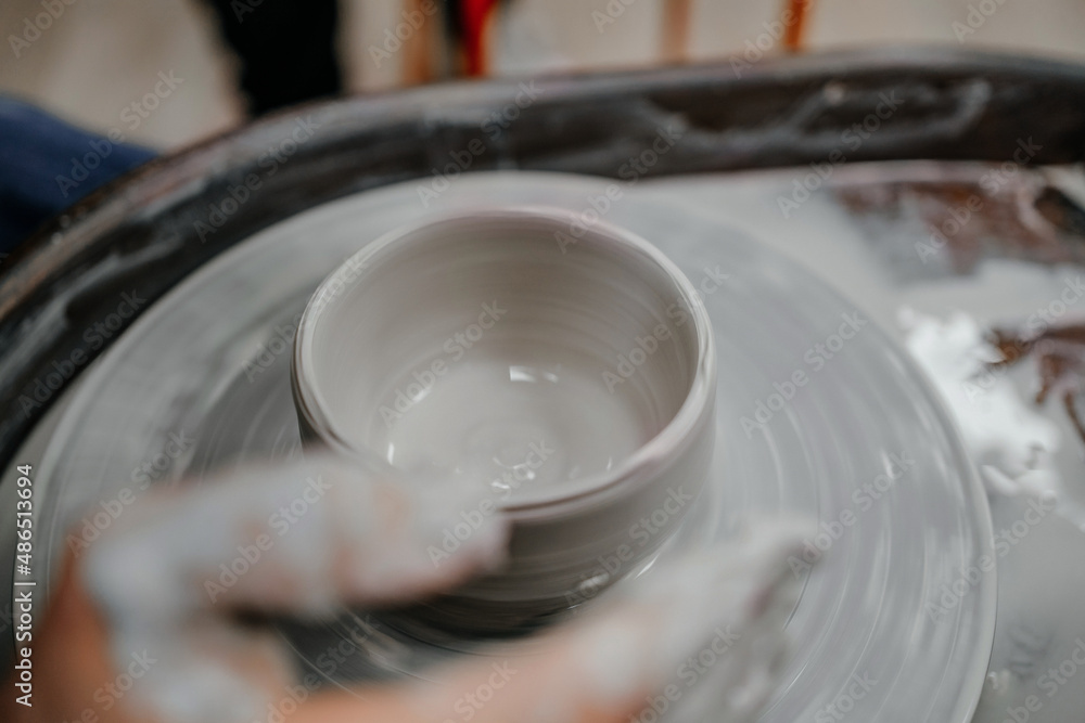 Fototapeta premium Modeling clay on a potter's wheel