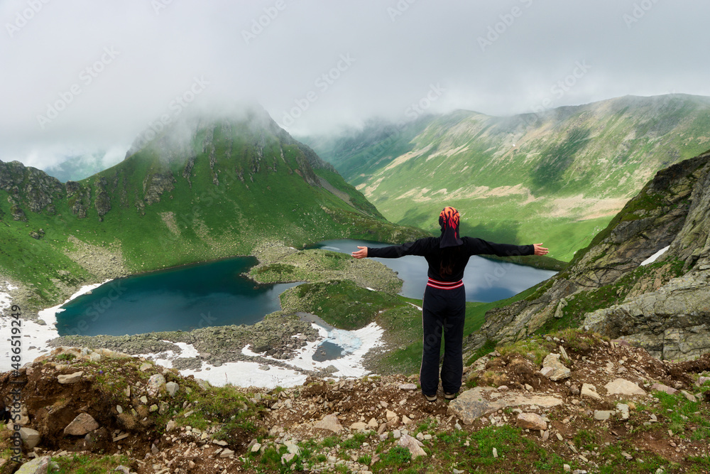 Hiker woman enjoying lake and mountains view Travel Lifestyle motivation concept adventure vacations outdoor