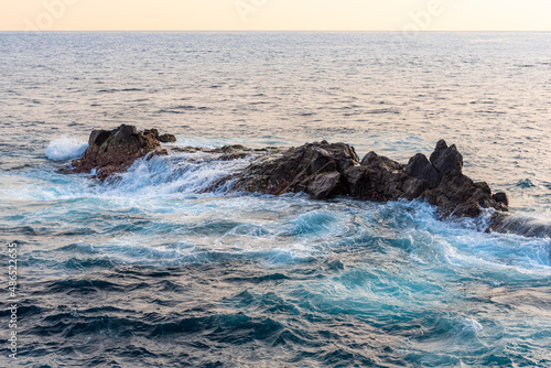 Breaking waves at the cliffs of coastel rock formations in front of the Canary Island of La Gomera