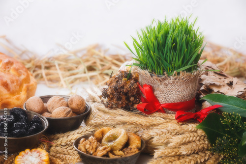 Orthodox Christmas Traditions. Yule log or badnjak, green wheat and   traditional food on Orthodox Christmas Eve. Close up, copy space photo