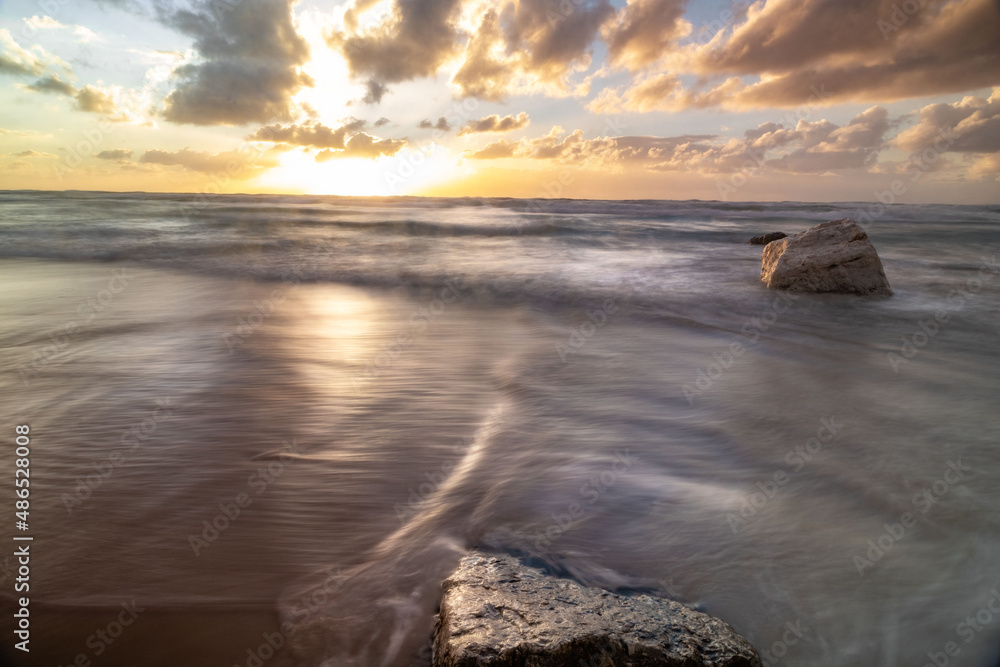 Naklejka premium Low angle wide view of the sunset at the sea Poleg beach Israel. Reflection of the sky