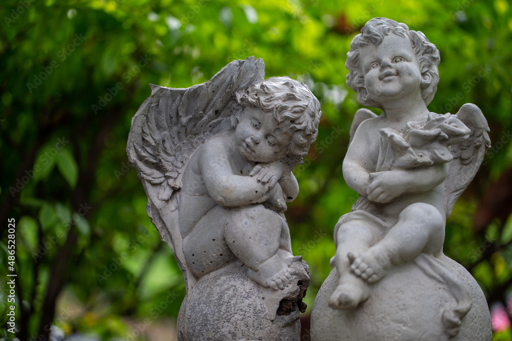 Sculpture of angel in the park. Image made vintage tone. Sculpture of angel in the park. Image made vintage tone.