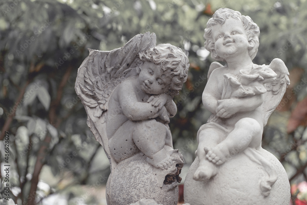 Sculpture of angel in the park. Image made vintage tone. Sculpture of angel in the park. Image made vintage tone.
