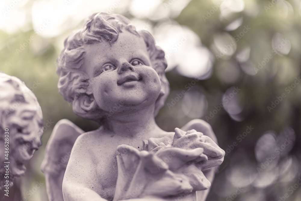 Sculpture of angel in the park. Image made vintage tone. Sculpture of angel in the park. Image made vintage tone.