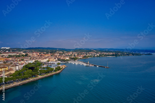 Top view of the boat parking on the lake. Aerial panorama of the town of Desenzano del Garda on Lake Garda in Italy. Italian resorts on Lake Garda. Aerial view of Desenzano del Garda. © Berg