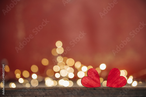 Red heart, valentine's day greeting card. Bokeh background. Two hearts on wooden background with bokeh lights