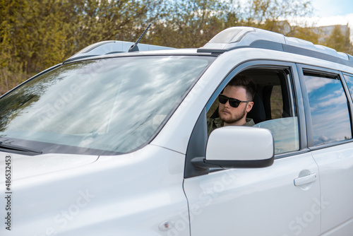 bearded man steering the car