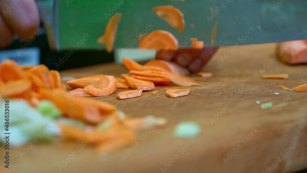 Slicing carrots and celery by a professional chef Slicing carrots and celery by a professional chef