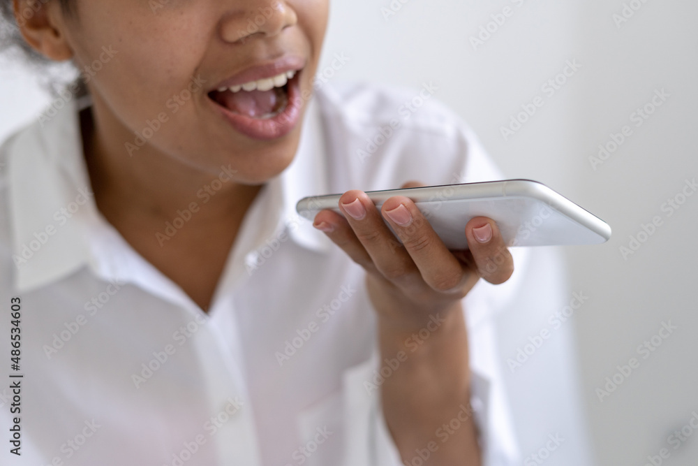 Afro american girl talking on speakerphone with friends Afro american girl talking on speakerphone with friends