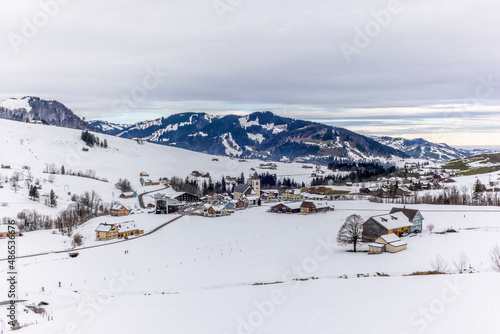 Skiers starting a ski tour from the village of Bruelisau in the Swiss canton of Appenzell in winter