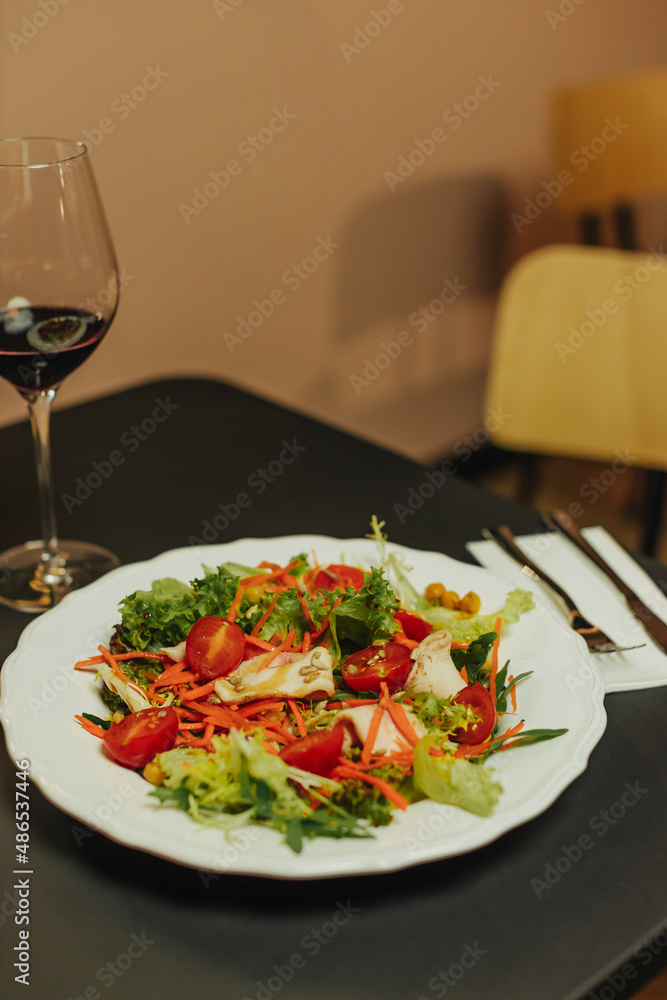 Girl is tasting alcoholic beverage and cheese. Traditional restaurant plate of food and wine Girl is tasting alcoholic beverage and cheese. Traditional restaurant plate of food and wine