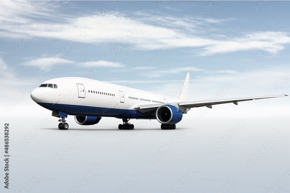Wide body passenger aircraft isolated on bright background with sky