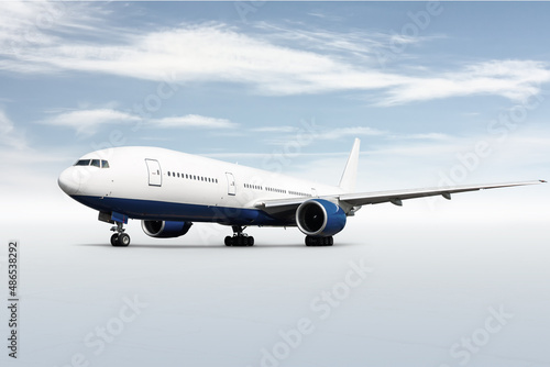 Wide body passenger aircraft isolated on bright background with sky