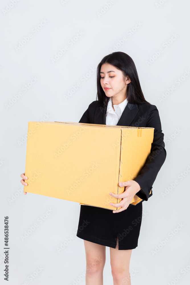 Business woman holding brown box, fired from her job. Business woman holding brown box, fired from her job.