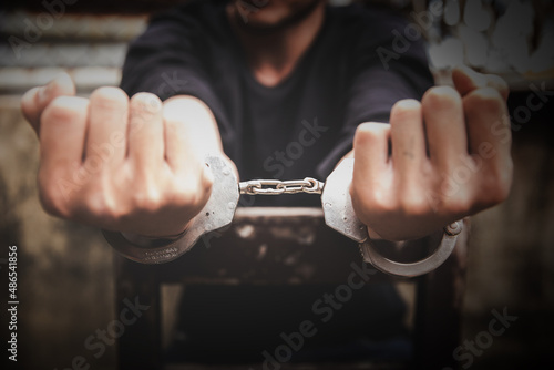 criminal tying hands with handcuffs.