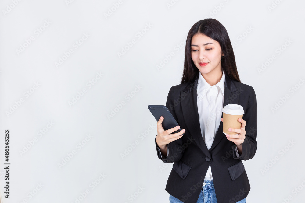 Entrepreneur pretty woman holding coffee cup and touching screen on smart phone mobile on white background, attractive asian people drink beverage smart, Technology communication lifestyles concept. Entrepreneur pretty woman holding coffee cup and touching screen on smart phone mobile on white background, attractive asian people drink beverage smart, Technology communication lifestyles concept.