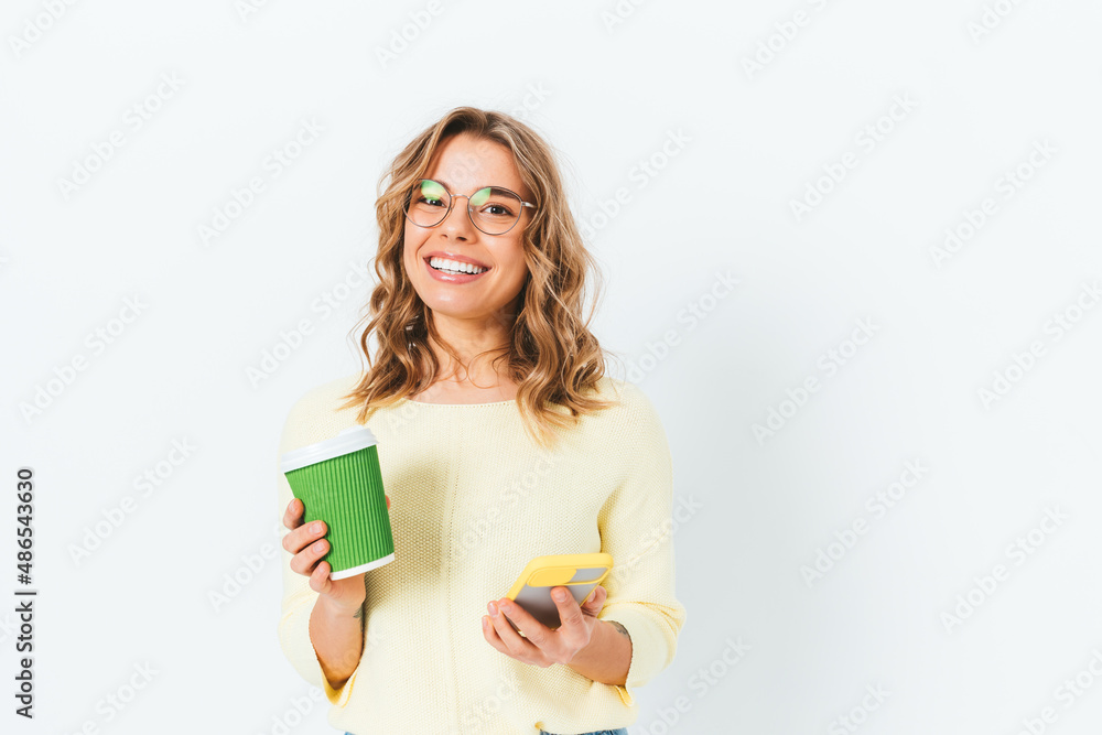 Smiling woman holding paper cup of coffee Smiling woman holding paper cup of coffee