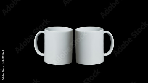 Two white cups on black background facing each other