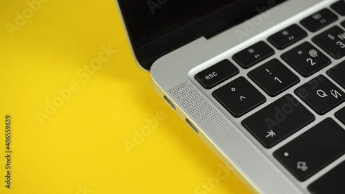 Person hand pull out or extract a USB-C cable charger from computer or laptop after charging. Close-up view