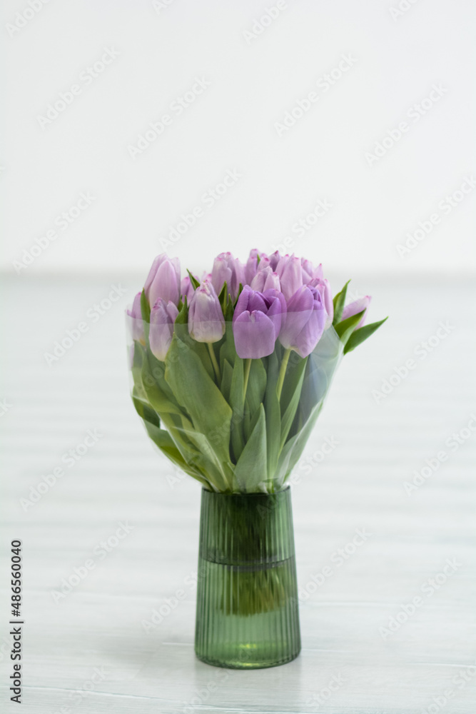 pink tulips in vase on table