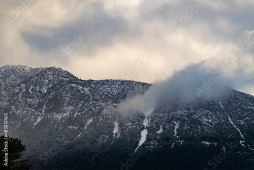 Foggy Snowy Mountains. Magical atmosphere of a foggy morning in a mountain. Copy paste banner space.  © burhan