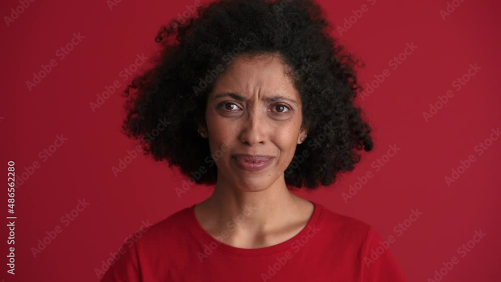 Concentrated African woman negatively shaking head in the red studio Concentrated African woman negatively shaking head in the red studio
